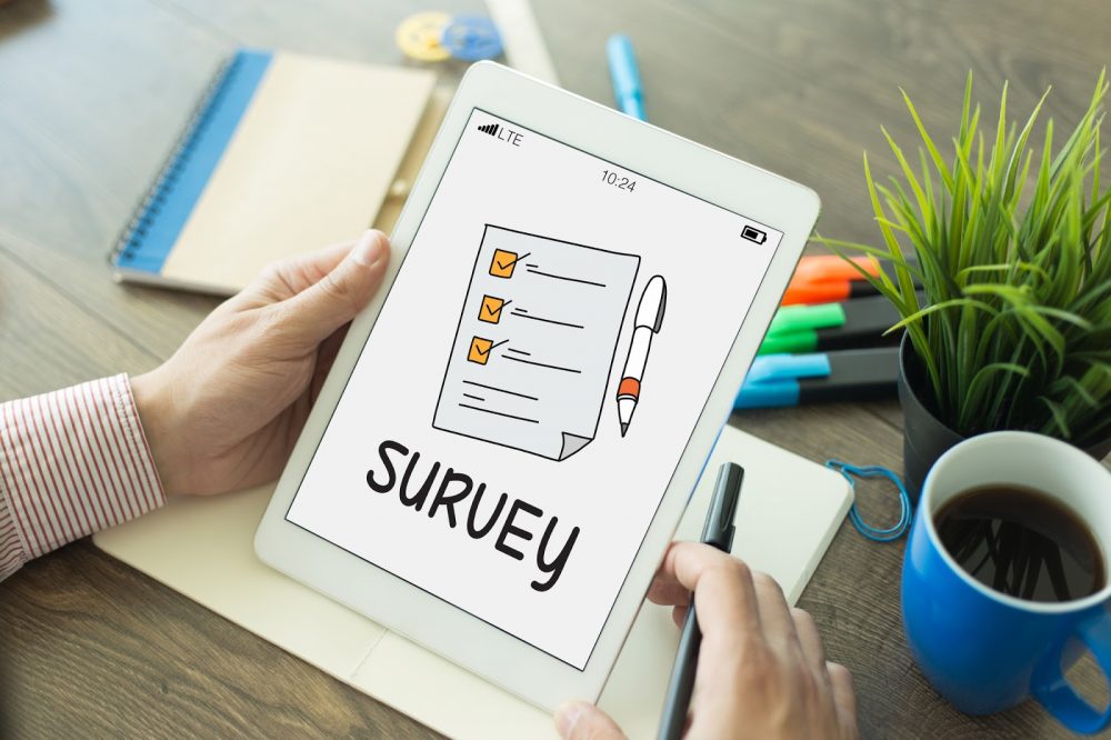 Pessoa segurando tablet com desenho de pesquisa na tela